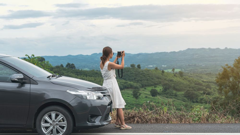 Tourist Taking Photo Mountain Road Car Stop - Bhutan Rental and Travel Blog